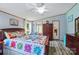 Comfortable bedroom featuring beautiful quilt, wood furniture, and view to the outdoors at 231 Valley View Dr, Clover, SC 29710
