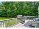 Outdoor deck featuring a grill, wicker furniture, and view of a lush, green backyard at 231 Valley View Dr, Clover, SC 29710