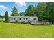 Charming single story home with blue shutters, a ramp, mature trees and a well manicured front yard at 231 Valley View Dr, Clover, SC 29710