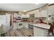 White kitchen with open shelving, modern appliances, and an adjacent laundry area at 231 Valley View Dr, Clover, SC 29710