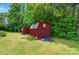 A bright red outbuilding in a green yard with an adjacent matching shed at 231 Valley View Dr, Clover, SC 29710