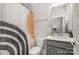 Bathroom showcasing a stylish vanity, modern fixtures, and shower with funky curtain at 235 S Bruns Ave, Charlotte, NC 28208