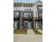 Townhome exterior featuring brick accents, a blue front door, and a balcony above the entry at 235 S Bruns Ave, Charlotte, NC 28208