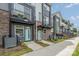 Charming townhome exterior with blue door and a small balcony on the second level at 235 S Bruns Ave, Charlotte, NC 28208