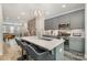 Open kitchen with stainless steel appliances, center island, and modern fixtures at 235 S Bruns Ave, Charlotte, NC 28208