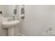 Clean half-bath features a pedestal sink and modern fixtures at 235 S Bruns Ave, Charlotte, NC 28208