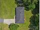 A bird's eye view of a home with a driveway and a dark roof, surrounded by a green lawn and mature trees at 2451 Robert H Kirk Rd, Lancaster, SC 29720