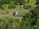 A bird's eye view of a brick home with a long driveway, surrounded by mature trees and green lawns at 2451 Robert H Kirk Rd, Lancaster, SC 29720