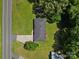 An aerial view of a home with a driveway, dark roof, and a well-kept lawn surrounded by mature trees at 2451 Robert H Kirk Rd, Lancaster, SC 29720