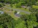 Aerial shot showcases a home with a long driveway, a green yard, and beautiful mature trees at 2451 Robert H Kirk Rd, Lancaster, SC 29720