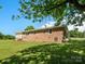 A brick house with a back entrance and a small staircase in a lush, green yard at 2451 Robert H Kirk Rd, Lancaster, SC 29720