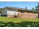 A brick home with a step-down entrance to the backyard, surrounded by a green lawn at 2451 Robert H Kirk Rd, Lancaster, SC 29720