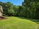 Spacious backyard with new stairs leading to a beautiful, well-manicured green lawn at 2451 Robert H Kirk Rd, Lancaster, SC 29720