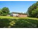 A charming brick home with a backyard entrance, complemented by a spacious green lawn at 2451 Robert H Kirk Rd, Lancaster, SC 29720