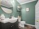 Stylish bathroom with dark green walls, a modern sink, and decorative mirror at 2451 Robert H Kirk Rd, Lancaster, SC 29720