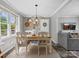 Cozy dining room features a modern light fixture, decorative wall baskets, and a window view at 2451 Robert H Kirk Rd, Lancaster, SC 29720
