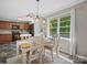 Charming dining area with natural light from a window, adjacent to the kitchen with modern appliances and cabinetry at 2451 Robert H Kirk Rd, Lancaster, SC 29720