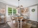 Inviting dining room featuring a bright window, stylish light fixture, and a rustic wooden table with seating for four at 2451 Robert H Kirk Rd, Lancaster, SC 29720