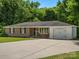 Ranch-style home with a brick facade, an attached garage, and a spacious driveway at 2451 Robert H Kirk Rd, Lancaster, SC 29720