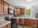 Kitchen featuring wooden cabinets, black appliances, and sleek countertops at 2451 Robert H Kirk Rd, Lancaster, SC 29720