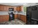 Efficient kitchen featuring wooden cabinets, black appliances, and sleek countertops at 2451 Robert H Kirk Rd, Lancaster, SC 29720