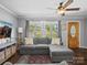 Bright living room features hardwood floors, a ceiling fan, and a cozy gray sectional at 2451 Robert H Kirk Rd, Lancaster, SC 29720