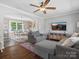 Open living room and dining area featuring hardwood floors, a plush gray sectional, and abundant natural light at 2451 Robert H Kirk Rd, Lancaster, SC 29720
