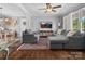 Comfortable living room featuring hardwood floors, gray sofa and chairs, large windows, and an open layout to the dining area at 2451 Robert H Kirk Rd, Lancaster, SC 29720