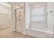 Modern bathroom featuring a glass-enclosed shower, soaking tub, and a walk-in closet at 2760 Berkhamstead Cir, Concord, NC 28027