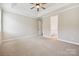 Large bedroom featuring a tray ceiling, neutral carpet and an ensuite bathroom at 2760 Berkhamstead Cir, Concord, NC 28027