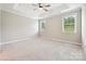 Spacious bedroom with a tray ceiling, neutral carpet, and ample natural light from two windows at 2760 Berkhamstead Cir, Concord, NC 28027
