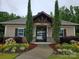 A quaint clubhouse with pine trees on each side at 2760 Berkhamstead Cir, Concord, NC 28027