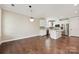 Cozy dining area featuring hardwood floors, pendant lighting, and open concept view to the kitchen at 2760 Berkhamstead Cir, Concord, NC 28027