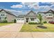 A quaint two-story home features a well-maintained lawn, 2-car garage and a landscaped yard at 2760 Berkhamstead Cir, Concord, NC 28027