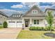 Charming home with a two-car garage, inviting front porch, manicured lawn, and appealing architectural details at 2760 Berkhamstead Cir, Concord, NC 28027