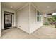 Inviting front porch featuring white siding, stone accents, and a stylish black front door at 2760 Berkhamstead Cir, Concord, NC 28027