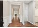 Elegant hallway with hardwood floors, wainscoting, and views of the living area with a fireplace at 2760 Berkhamstead Cir, Concord, NC 28027