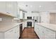 Contemporary kitchen features stainless steel appliances, white cabinetry, and quartz countertops at 2760 Berkhamstead Cir, Concord, NC 28027