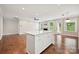 Spacious kitchen island with white cabinets, quartz countertops, and hardwood flooring in the home's open layout at 2760 Berkhamstead Cir, Concord, NC 28027