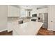 Modern kitchen with white cabinets, stainless steel appliances, quartz countertops, and island at 2760 Berkhamstead Cir, Concord, NC 28027