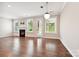 Bright living room with a modern fireplace, gleaming hardwood floors, and access to the outdoors at 2760 Berkhamstead Cir, Concord, NC 28027