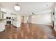 Open concept kitchen and living room with stainless steel appliances and hardwood floors throughout at 2760 Berkhamstead Cir, Concord, NC 28027