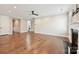 Spacious living room with hardwood floors, fireplace, and open doorway leading to other rooms at 2760 Berkhamstead Cir, Concord, NC 28027