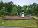 Community playground with play structure and surrounding wooded area at 2760 Berkhamstead Cir, Concord, NC 28027