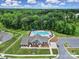 Aerial of the community pool surrounded by mature trees, parking, and sidewalks at 300 Kennerly Center Dr, Mooresville, NC 28115