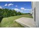 A concrete patio and expansive backyard bordered by a black fence and lush trees offer outdoor possibilities at 300 Kennerly Center Dr, Mooresville, NC 28115