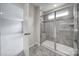Shower with tile surround with seat and window and view to bedroom at 300 Kennerly Center Dr, Mooresville, NC 28115