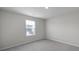 Bedroom featuring neutral paint, carpet, a window, and base molding at 300 Kennerly Center Dr, Mooresville, NC 28115