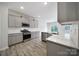 Modern kitchen featuring stainless steel appliances, gray cabinets, quartz countertops, and wood-style floors at 300 Kennerly Center Dr, Mooresville, NC 28115