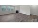 Bright living area with wood-style floors, a fireplace, and large windows for plenty of natural light at 300 Kennerly Center Dr, Mooresville, NC 28115